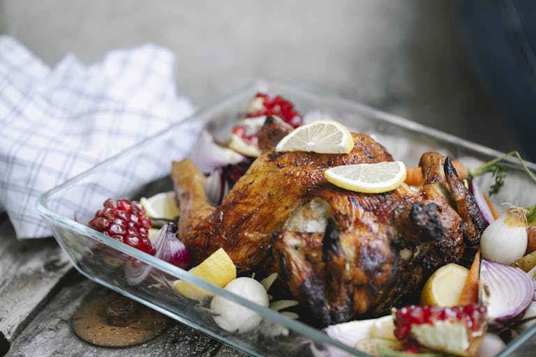 Delicious roasted chicken with vegetables in glass form