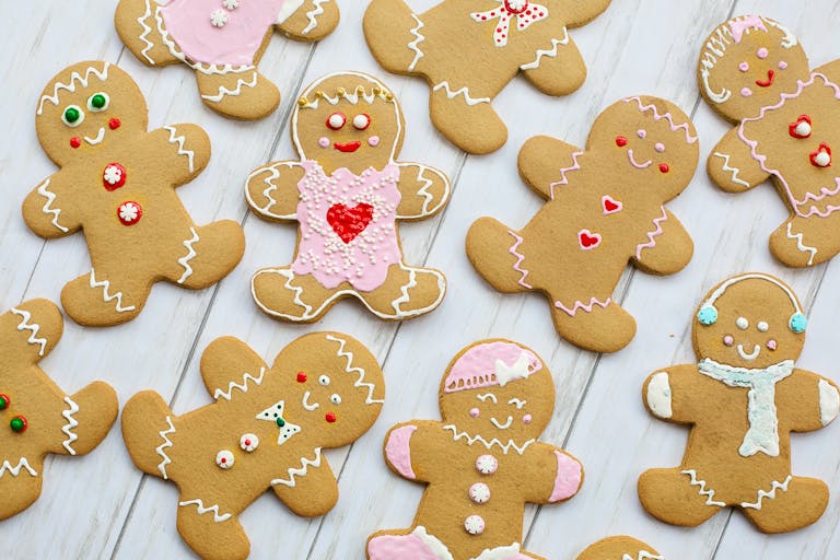 A delightful assortment of decorated gingerbread cookies on a wooden table, perfect for the holiday season.